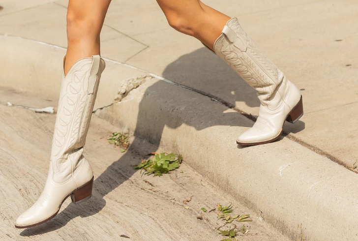 Are tall boots still in style for summer? Opt for lighter colors and breathable materials.